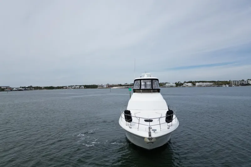 Slide: The Image of 2007 Sea Ray 52 Sedan Bridge yacht on calm waters, distant shoreline visible. - 4