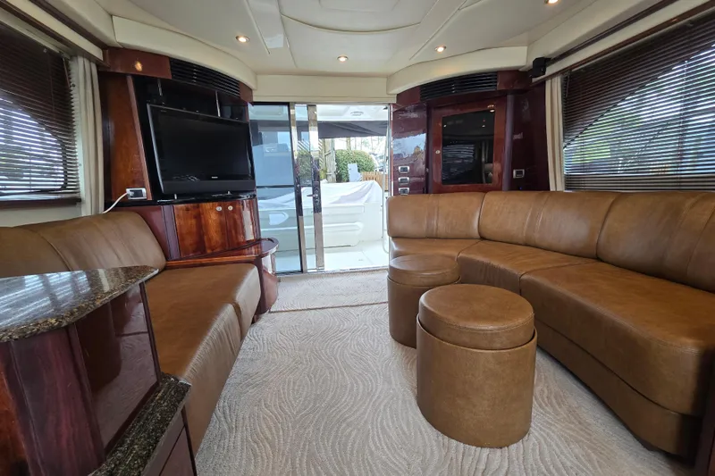 Slide: The Image of Luxurious interior of 2007 Sea Ray 52 Sedan Bridge yacht with leather seating and TV. - 42