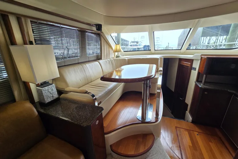 Slide: The Image of Luxurious interior of 2007 Sea Ray 52 Sedan Bridge yacht with elegant seating and wooden flooring. - 44