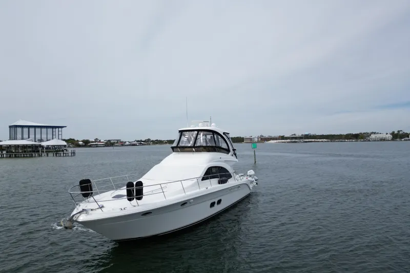 Slide: The Image of 2007 Sea Ray 52 Sedan Bridge yacht cruising on calm waters. - 5