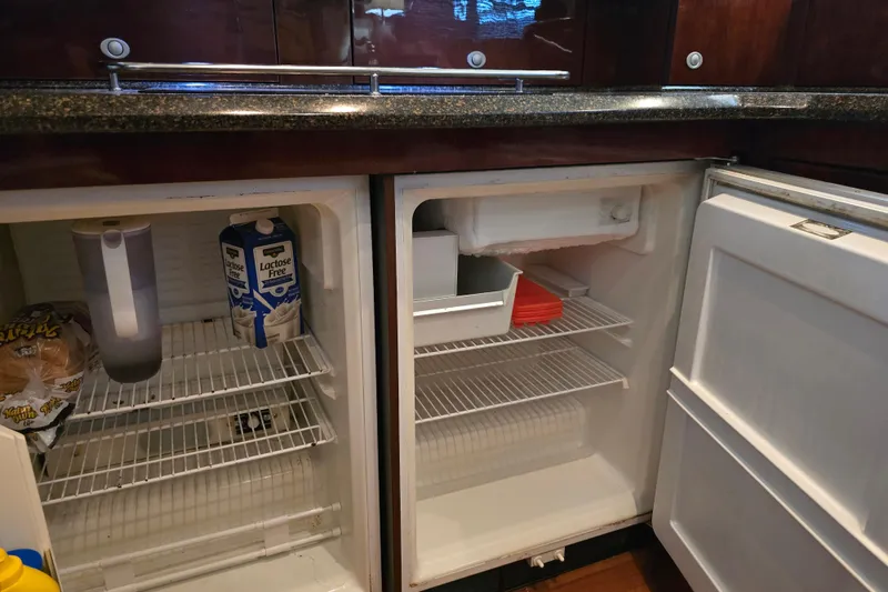 Slide: The Image of Refrigerator interior on 2007 Sea Ray 52 Sedan Bridge yacht, featuring lactose-free milk and bread. - 52