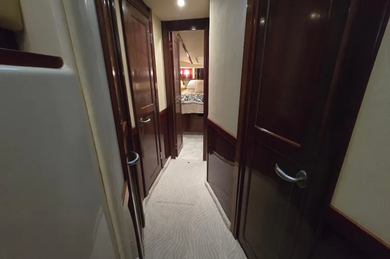Slide: The Image of Interior hallway of 2007 Sea Ray 52 Sedan Bridge yacht with wooden doors and carpet. - 53
