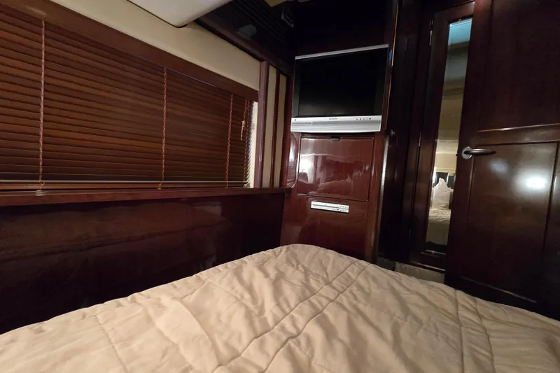 Slide: The Image of Luxurious cabin interior of 2007 Sea Ray 52 Sedan Bridge with TV and wooden blinds. - 55