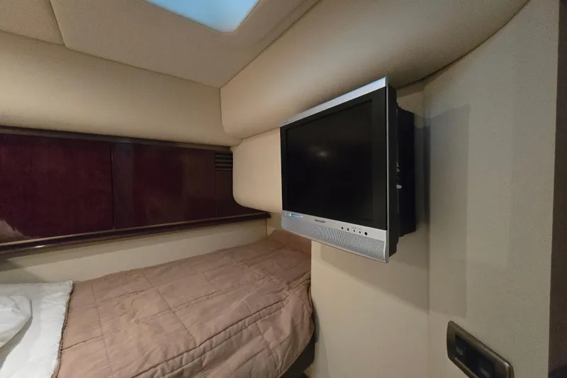 Slide: The Image of 2007 Sea Ray 52 Sedan Bridge cabin with wall-mounted TV and cozy bed. - 60