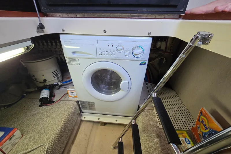 Slide: The Image of Laundry area with a washing machine inside a 2007 Sea Ray 52 Sedan Bridge yacht. - 67