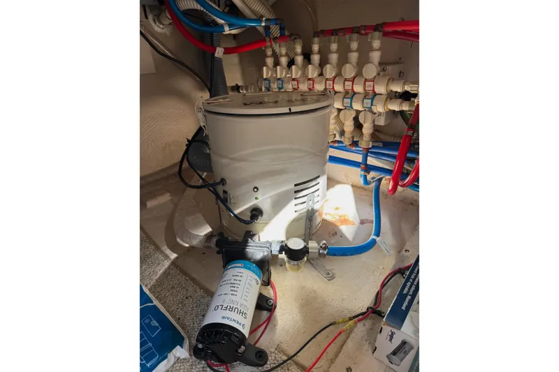 Slide: The Image of Engine room of 2007 Sea Ray 52 Sedan Bridge with water pump and plumbing. - 69