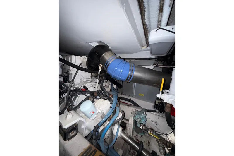 Slide: The Image of Engine room of 2007 Sea Ray 52 Sedan Bridge with visible pipes and components. - 71