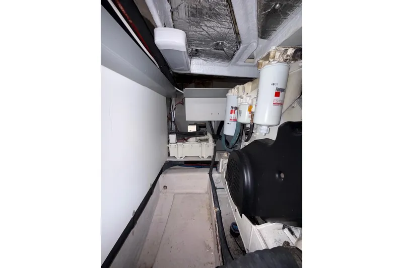 Slide: The Image of Engine room of 2007 Sea Ray 52 Sedan Bridge with visible filters and components. - 73