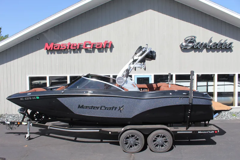 The Image of 2018 MasterCraft X23 boat in front of a showroom. - 1