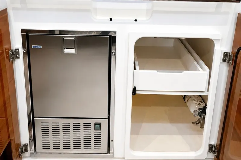 Slide: The Image of Interior of 2023 Tiara Yachts 48 LS with fridge and storage space. - 27