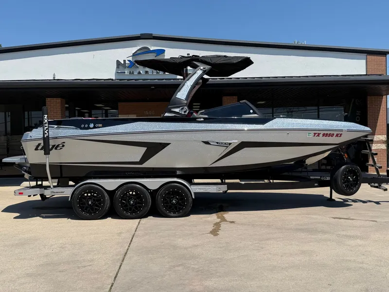 The Image of 2023 Tigé 24RZX boat on trailer in front of building. - 1
