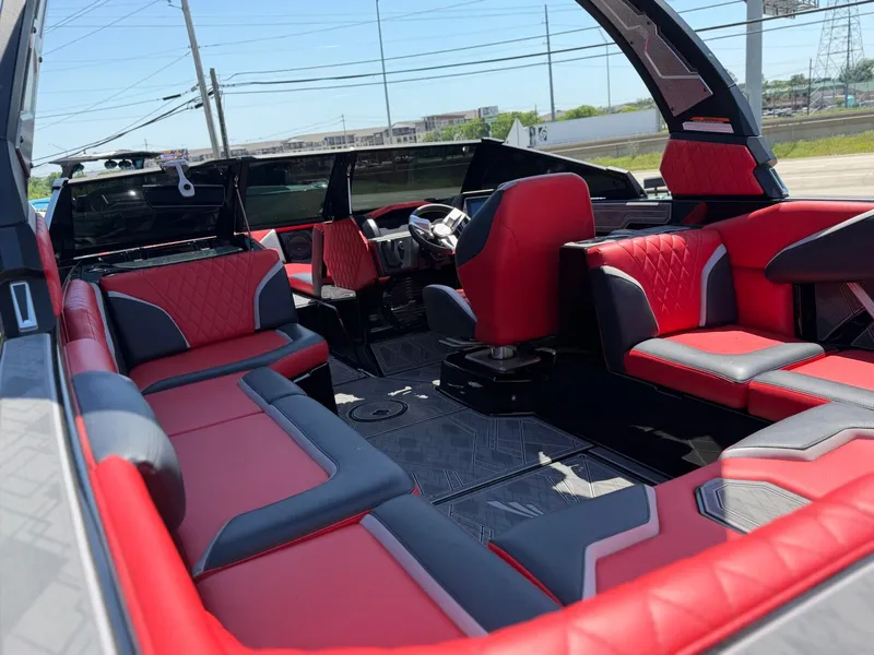 Slide: The Image of Interior of 2023 Tigé 24RZX with red and gray seating. - 10