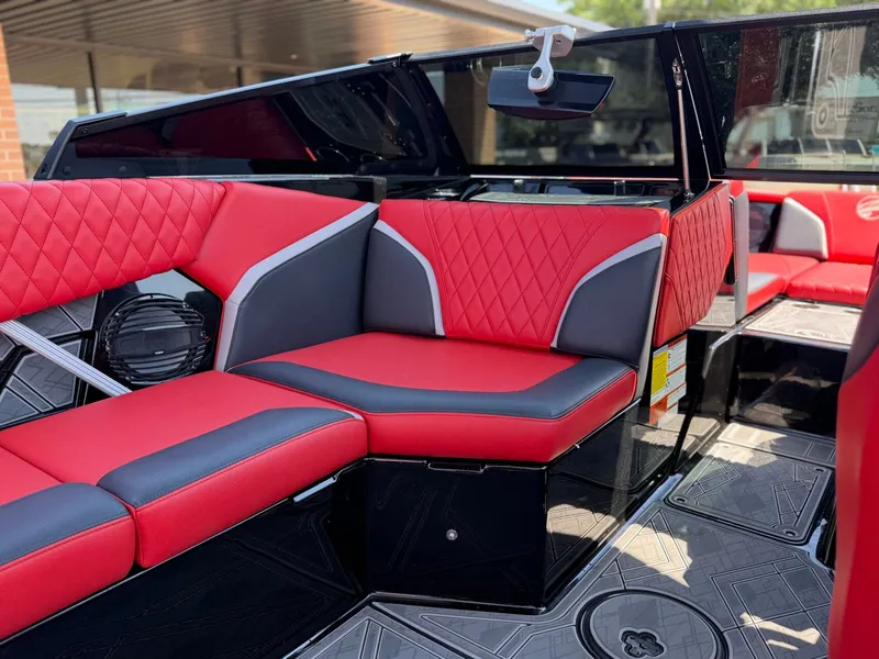 Slide: The Image of Interior of 2023 Tigé 24RZX with red and gray seating. - 13