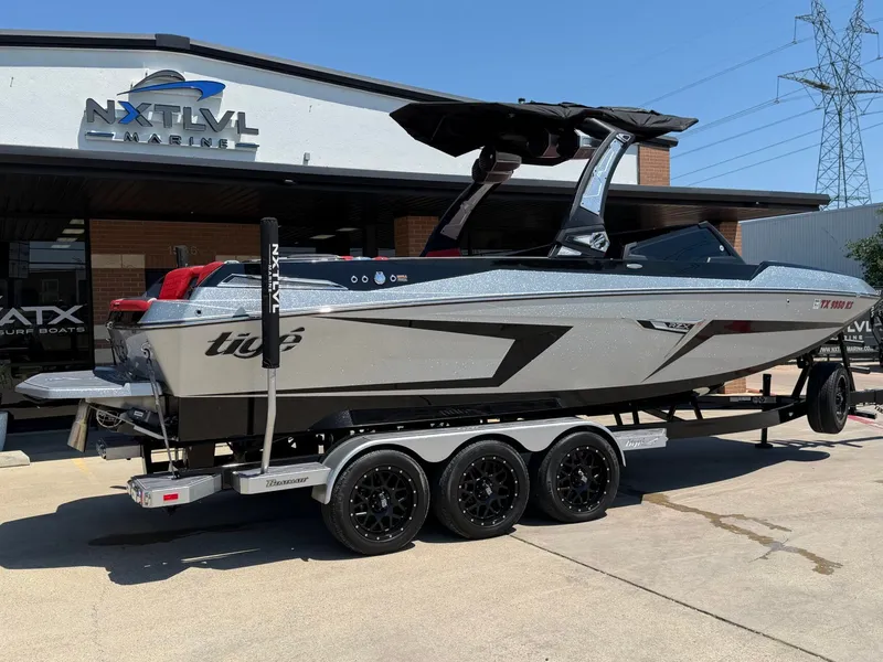 Slide: The Image of 2023 Tigé 24RZX boat outside NXT LVL Marine building. - 3