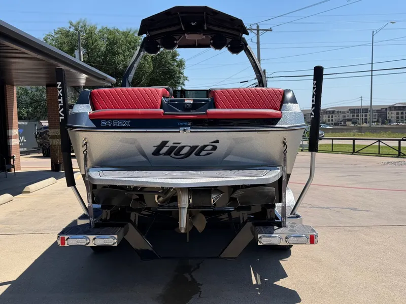Slide: The Image of Rear view of 2023 Tigé 24RZX boat with red seats. - 4