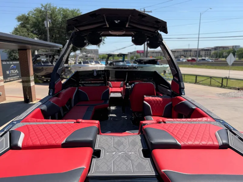 Slide: The Image of Interior of 2023 Tigé 24RZX with red and black seating. - 9