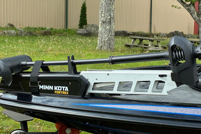 Slide: The Image of 2022 Skeeter ZX150 boat with Minn Kota Fortrex trolling motor in a grassy area. - 10