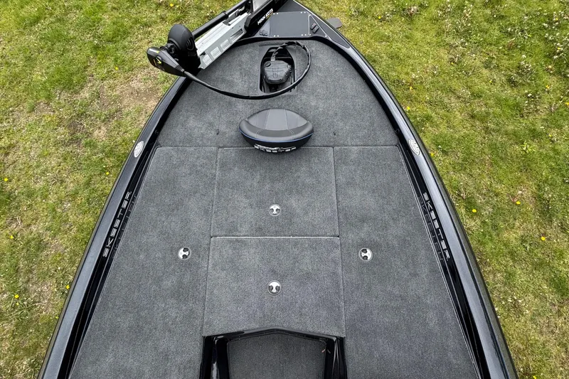 Slide: The Image of 2022 Skeeter ZX150 boat deck with trolling motor on grassy background. - 13