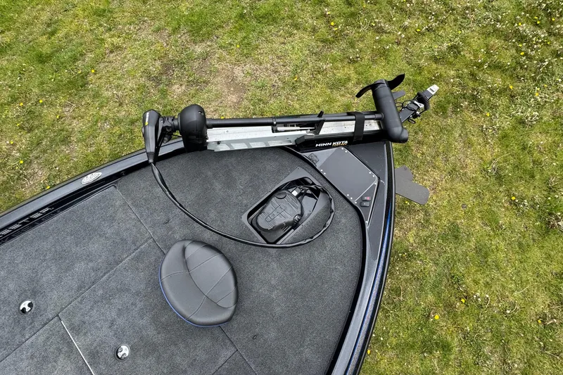 Slide: The Image of 2022 Skeeter ZX150 boat deck with Minn Kota trolling motor on grassy background. - 16
