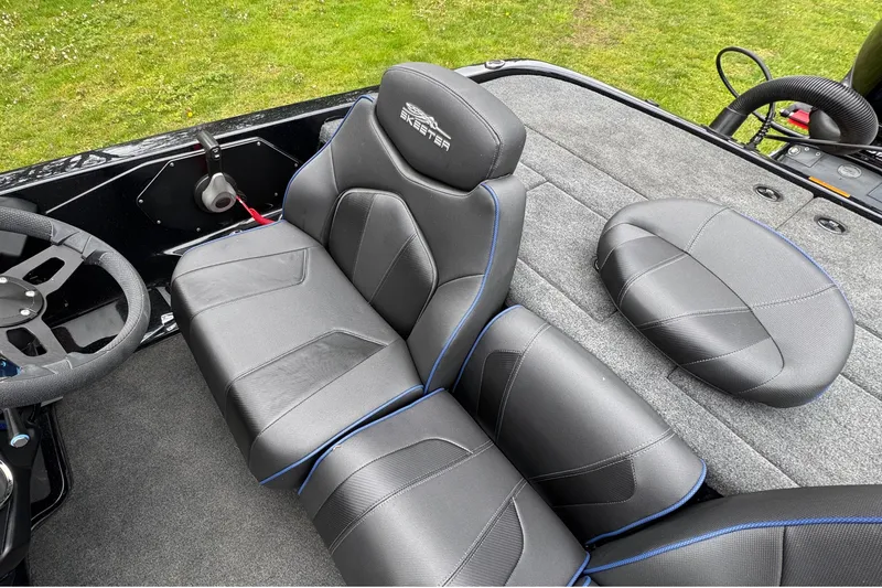 Slide: The Image of 2022 Skeeter ZX150 boat interior with black leather seats and steering wheel. - 17