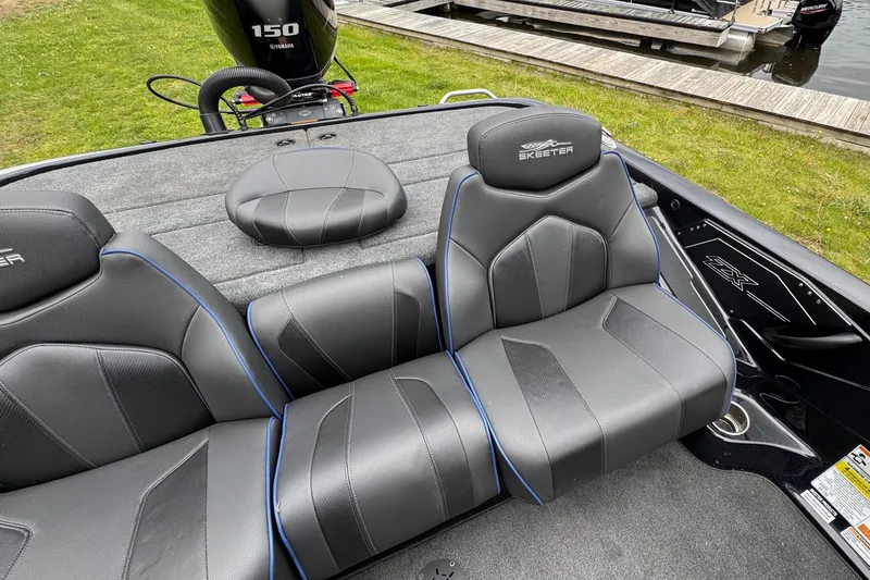 Slide: The Image of 2022 Skeeter ZX150 boat interior with sleek black seats and Yamaha 150 engine. - 18