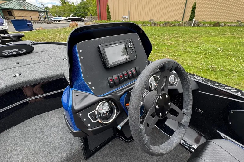 Slide: The Image of 2022 Skeeter ZX150 boat dashboard with steering wheel and electronic display. - 19