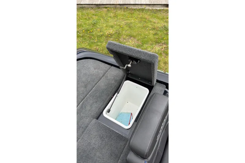 Slide: The Image of Open storage compartment in 2022 Skeeter ZX150 boat, showing interior details. - 24