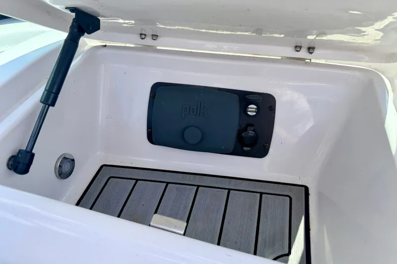 Slide: The Image of 2014 Nautique Super Air Nautique 210 storage compartment with Polk audio system. - 61