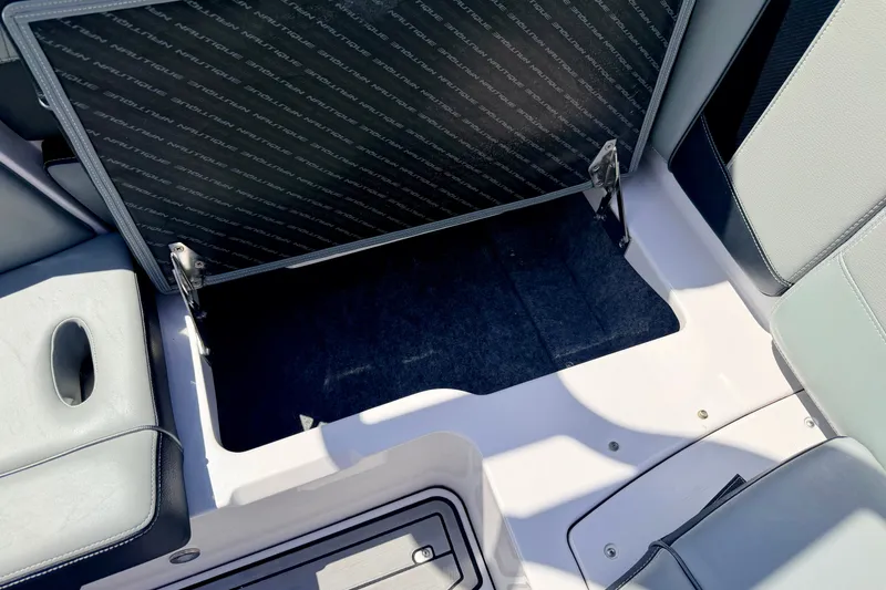 Slide: The Image of Open storage compartment in 2014 Nautique Super Air Nautique 210 boat interior. - 38