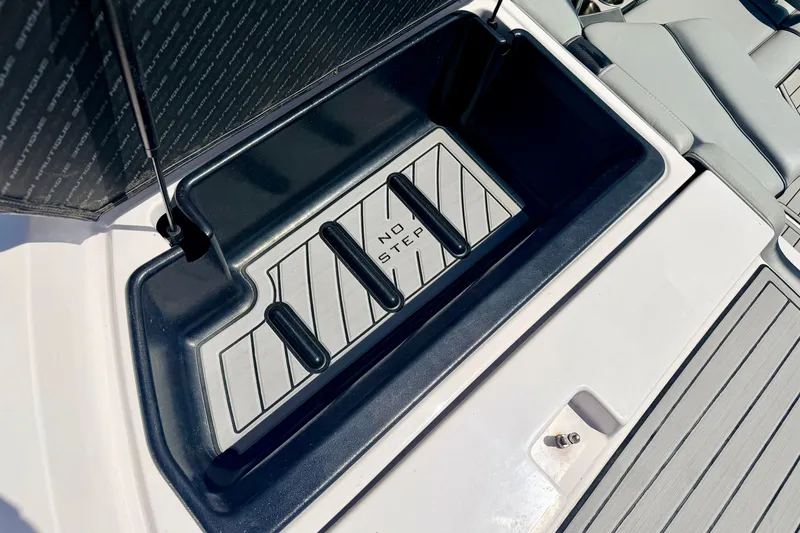 Slide: The Image of 2014 Nautique Super Air Nautique 210 storage compartment with "No Step" warning. - 27