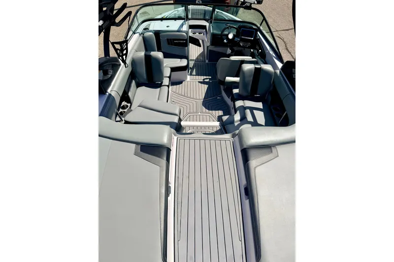 Slide: The Image of 2014 Nautique Super Air Nautique 210 interior with gray seating and sleek design. - 22