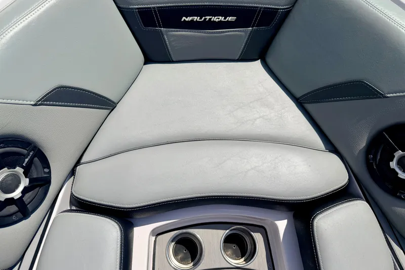 Slide: The Image of Interior seating of 2014 Nautique Super Air Nautique 210 boat with speakers and cup holders. - 70