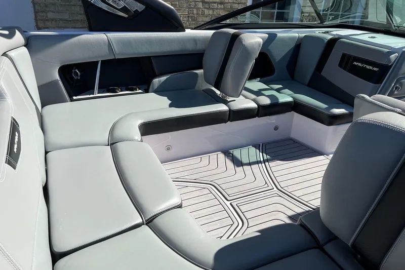 Slide: The Image of 2014 Nautique Super Air Nautique 210 interior with gray seating and modern design. - 12