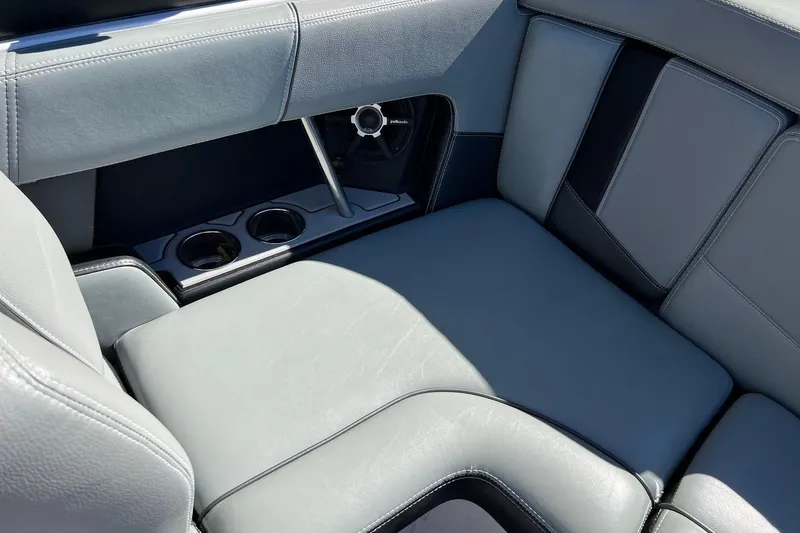 Slide: The Image of 2014 Nautique Super Air Nautique 210 interior with gray leather seats and cup holders. - 17