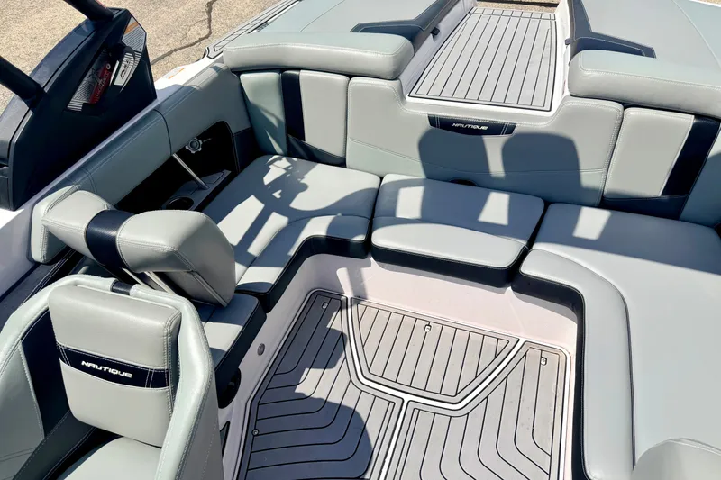 Slide: The Image of 2014 Nautique Super Air Nautique 210 interior with gray seating and sleek design. - 82