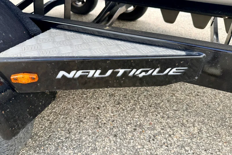 Slide: The Image of 2014 Nautique Super Air Nautique 210 trailer detail with logo and orange reflector. - 108
