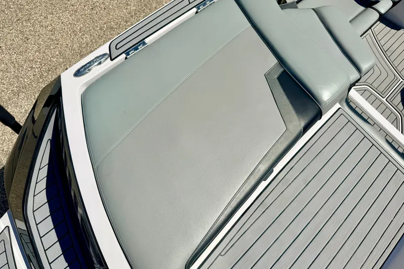 Slide: The Image of 2014 Nautique Super Air Nautique 210 boat interior with sleek gray seating and deck. - 26