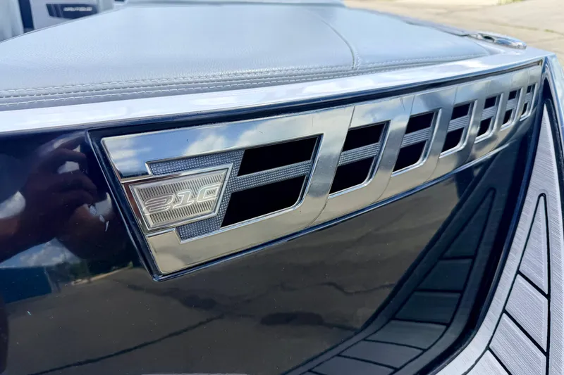 Slide: The Image of Close-up of 2014 Nautique Super Air Nautique 210 emblem and vent detail. - 97