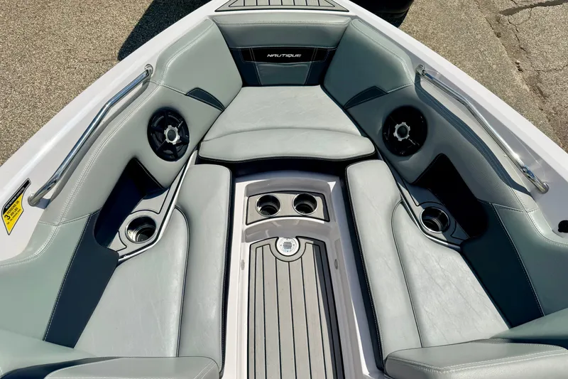 Slide: The Image of 2014 Nautique Super Air Nautique 210 boat interior with gray seating and cup holders. - 80