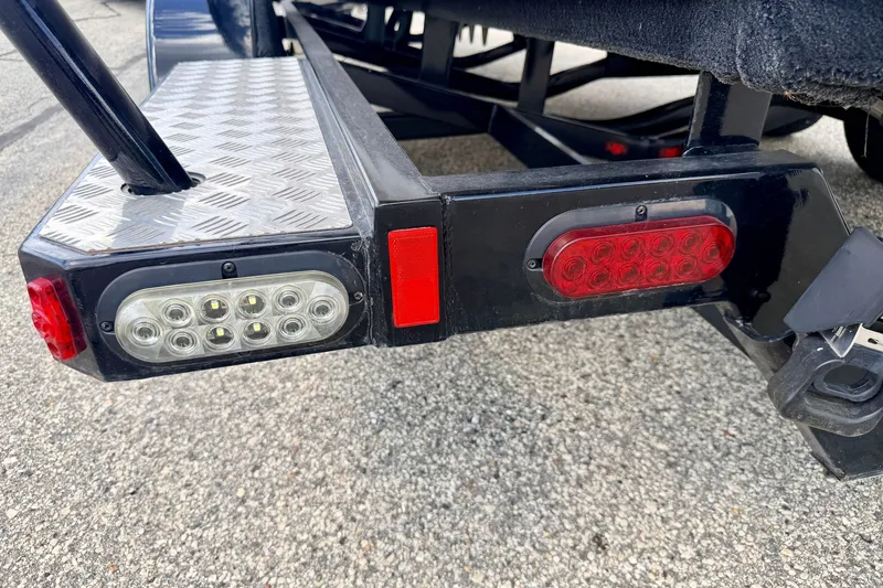 Slide: The Image of Trailer lights and step detail of a 2014 Nautique Super Air Nautique 210. - 105