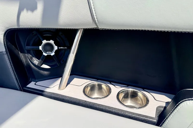 Slide: The Image of 2014 Nautique Super Air Nautique 210 interior with Polk Audio speaker and cup holders. - 95