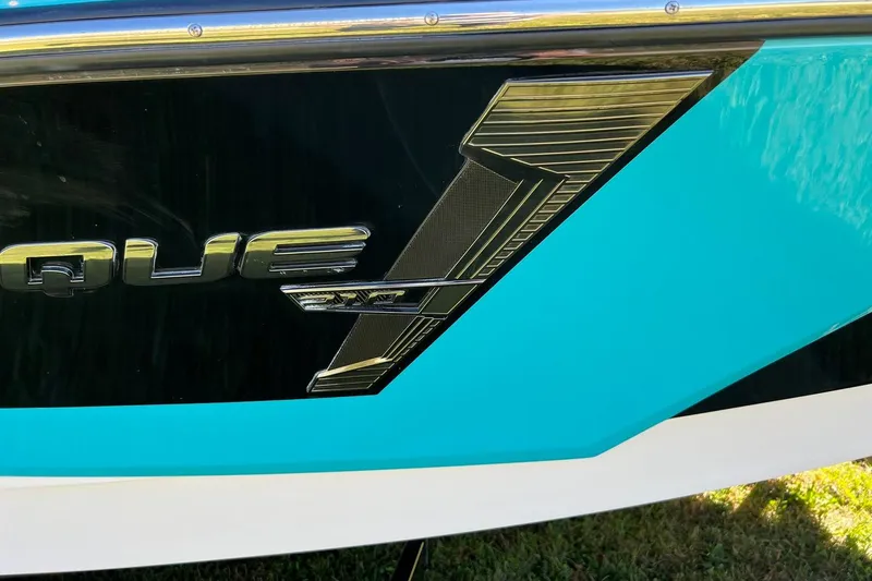 Slide: The Image of 2014 Nautique Super Air Nautique 210 boat emblem with turquoise and black design. - 5