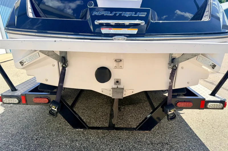 Slide: The Image of Rear view of a 2014 Nautique Super Air Nautique 210 boat on a trailer. - 17
