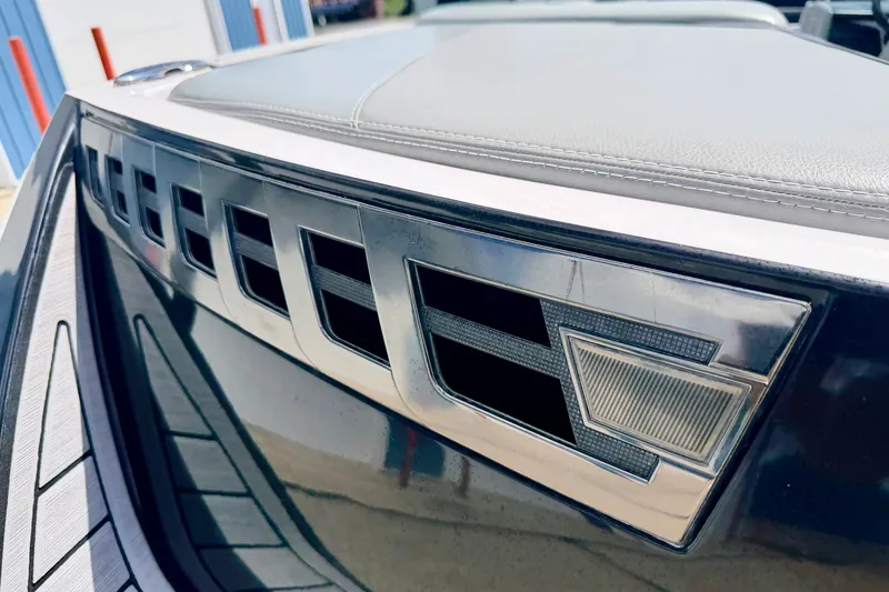 Slide: The Image of 2014 Nautique Super Air Nautique 210 boat detail with sleek metallic design elements. - 96
