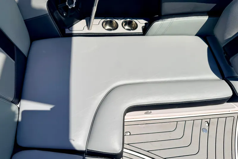 Slide: The Image of 2014 Nautique Super Air Nautique 210 interior seating with cup holders and sleek design. - 41