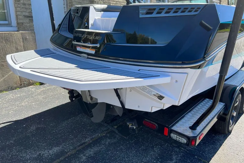 Slide: The Image of 2014 Nautique Super Air Nautique 210 boat rear view on trailer. - 6