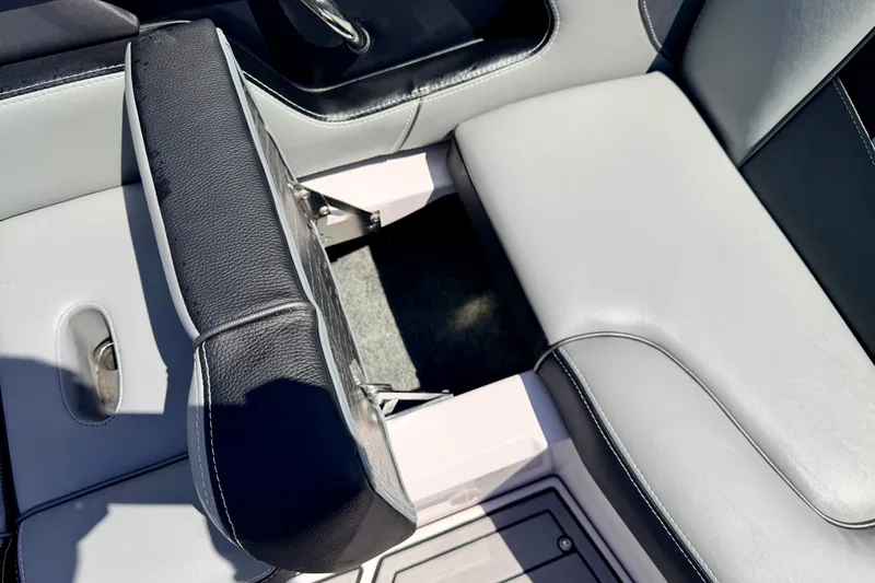 Slide: The Image of 2014 Nautique Super Air Nautique 210 interior seating detail with black and gray upholstery. - 46