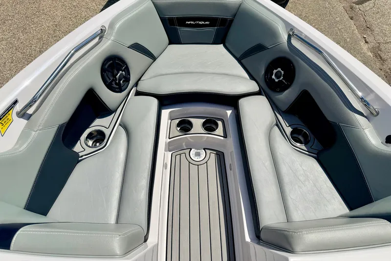 Slide: The Image of Interior of 2014 Nautique Super Air Nautique 210 boat with gray seating and cup holders. - 67