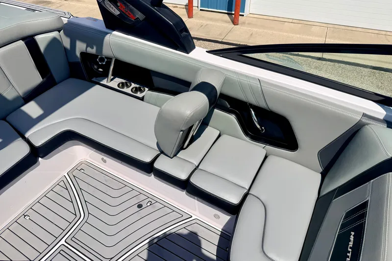 Slide: The Image of Interior of 2014 Nautique Super Air Nautique 210 boat with gray seating and cup holders. - 83