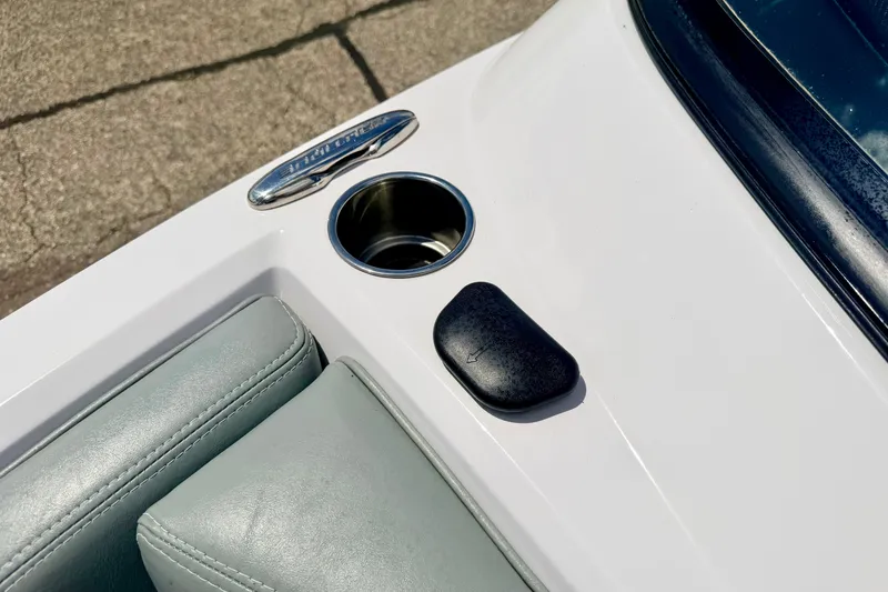 Slide: The Image of 2014 Nautique Super Air Nautique 210 boat interior detail with cup holder and upholstery. - 78